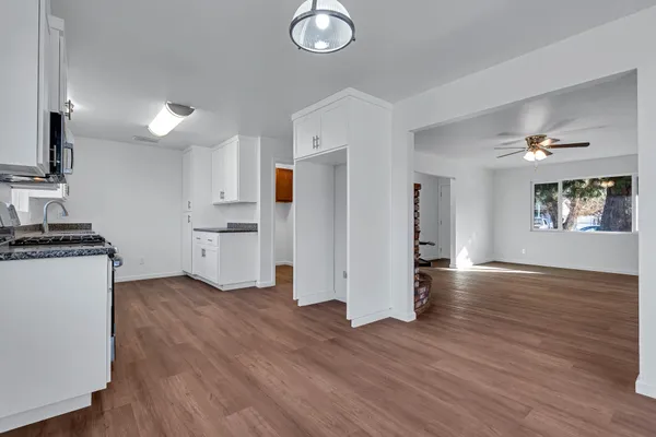 a kitchen with stainless steel appliances granite countertop a stove a sink and a microwave