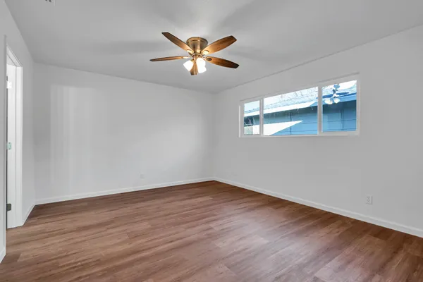 wooden floor in an empty room with a window