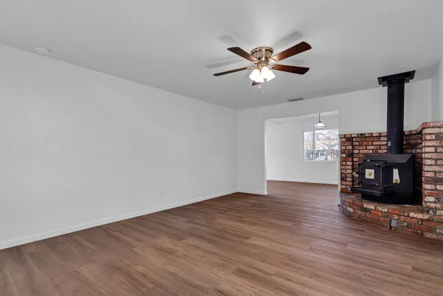 a view of wooden floor and windows in a room