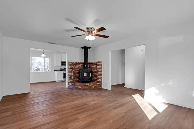 a view of a kitchen with wooden floor and a large window
