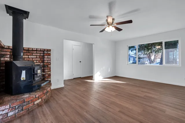 a view of a hallway with wooden floor and a large window