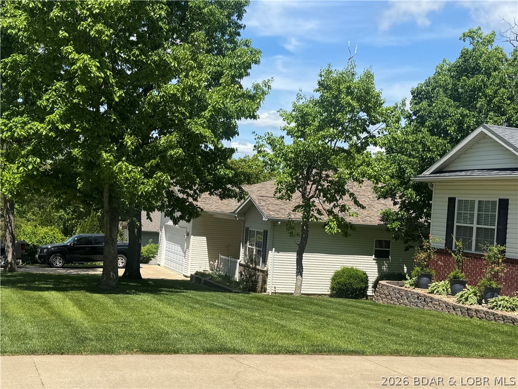 109 Reddington Road Four Seasons, MO 65049 - Photo 2 of 71 A beautifully manicured lawn and mature trees prov