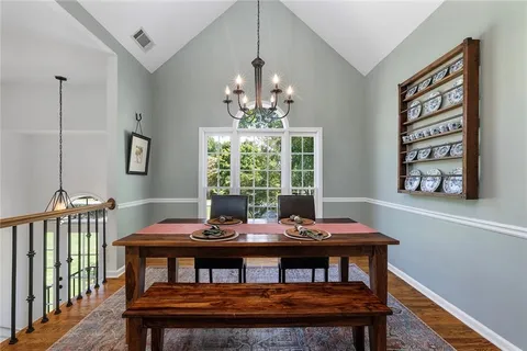 a kitchen with granite countertop a stove top oven sink and cabinets