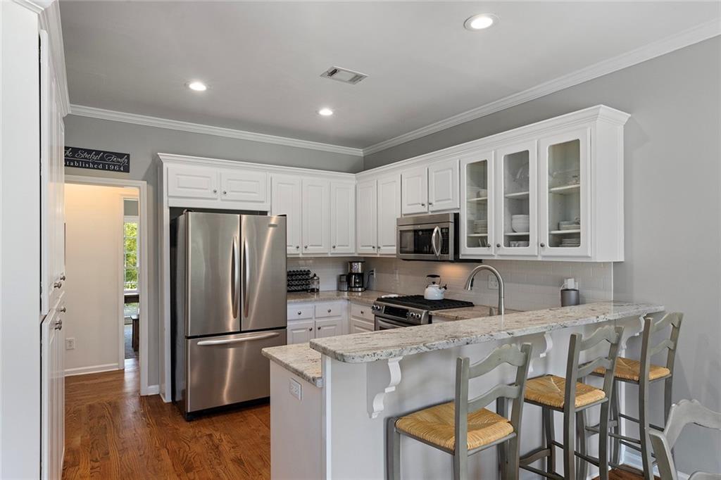 915 Taylor Parkway Suwanee, GA 30024 - Photo 18 of 61 a kitchen with stainless steel appliances a refrigerator stove microwave and cabinets