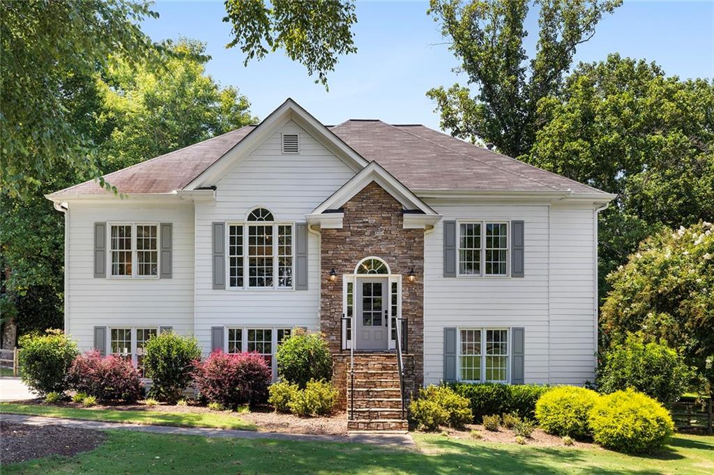 915 Taylor Parkway Suwanee, GA 30024 - Photo 2 of 61 a front view of a house with a yard and garage