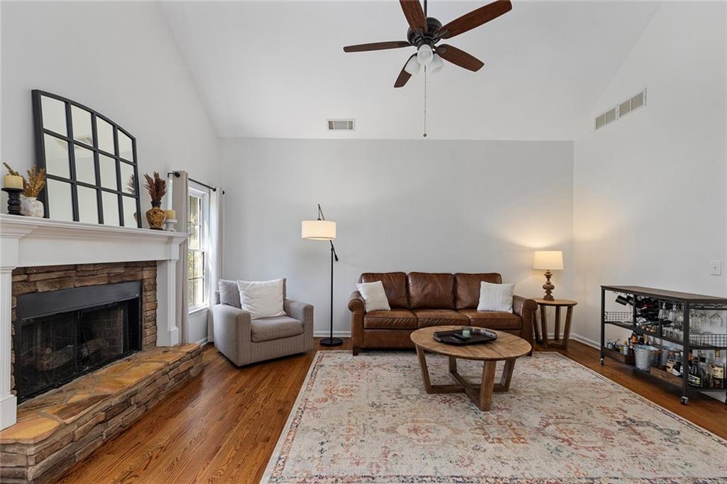 915 Taylor Parkway Suwanee, GA 30024 - Photo 23 of 61 a living room with furniture a rug and a fireplace