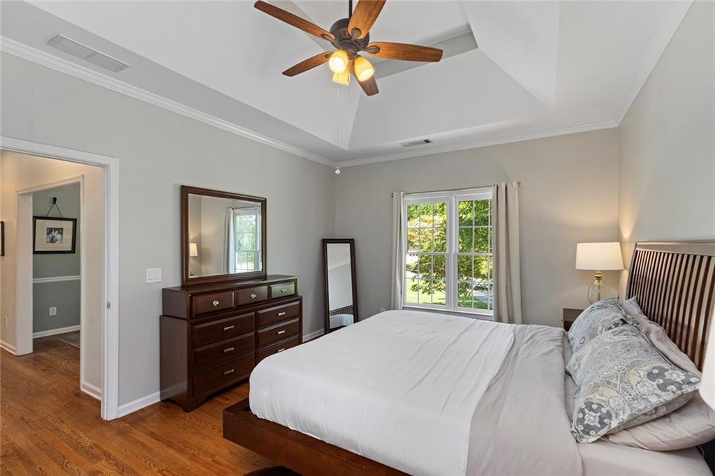 915 Taylor Parkway Suwanee, GA 30024 - Photo 31 of 61 a bedroom with a bed and a chandelier