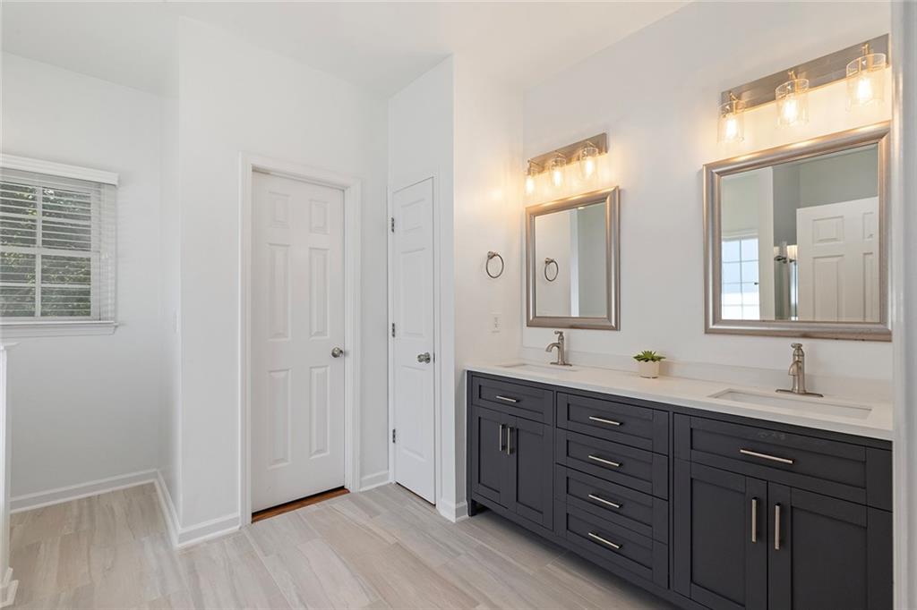 915 Taylor Parkway Suwanee, GA 30024 - Photo 33 of 61 a bathroom with a double vanity sink and a mirror