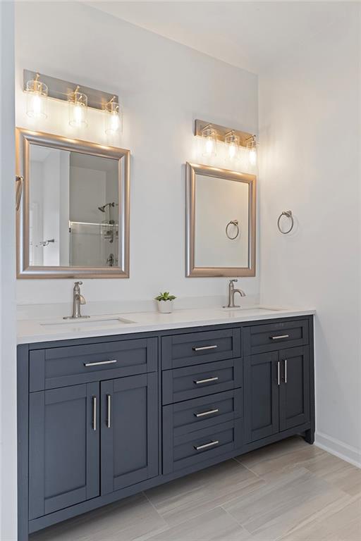 915 Taylor Parkway Suwanee, GA 30024 - Photo 35 of 61 a bathroom with a double vanity sink and mirror