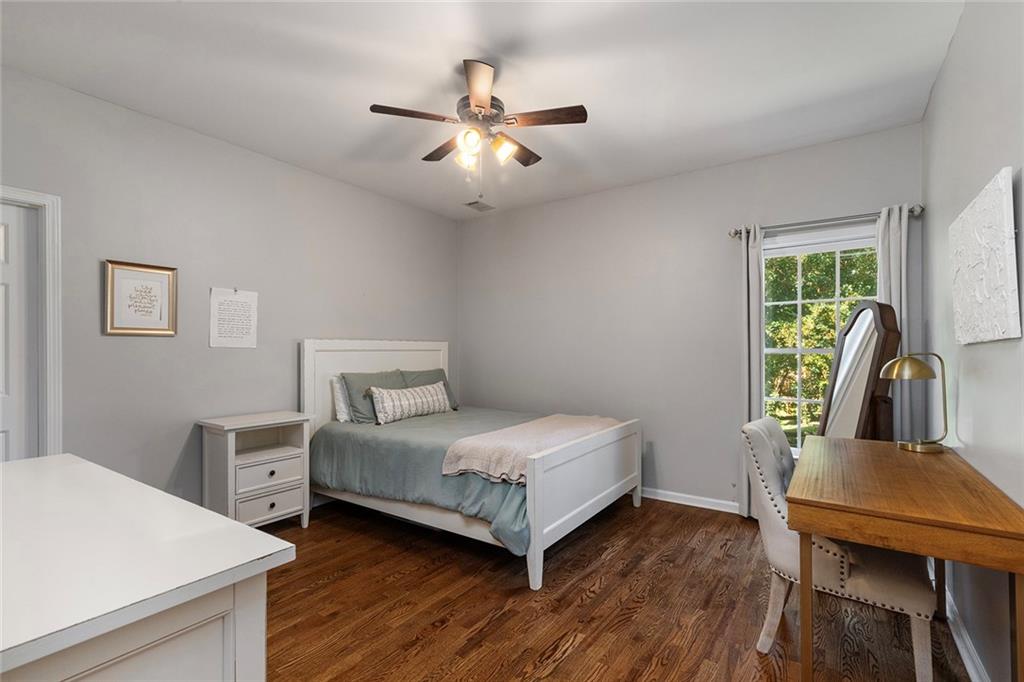 915 Taylor Parkway Suwanee, GA 30024 - Photo 45 of 61 a bedroom with a bed and a table