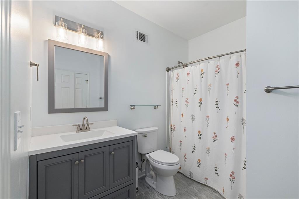 915 Taylor Parkway Suwanee, GA 30024 - Photo 46 of 61 a bathroom with a sink a toilet and shower curtain
