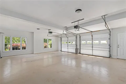 a view of a yard in front of a house with a large tree