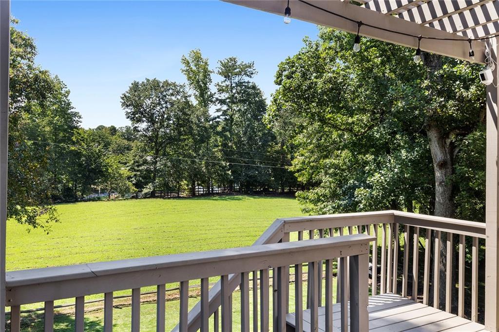 915 Taylor Parkway Suwanee, GA 30024 - Photo 50 of 61 a view of a wooden deck with a yard