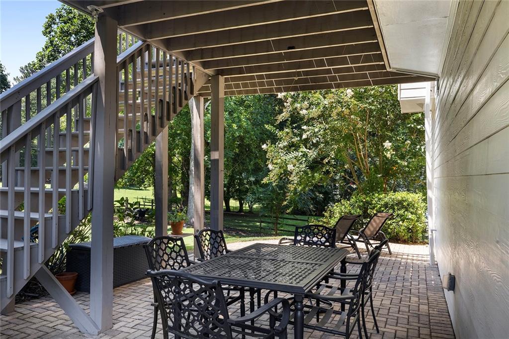 915 Taylor Parkway Suwanee, GA 30024 - Photo 51 of 61 a view of a patio with a table and chairs