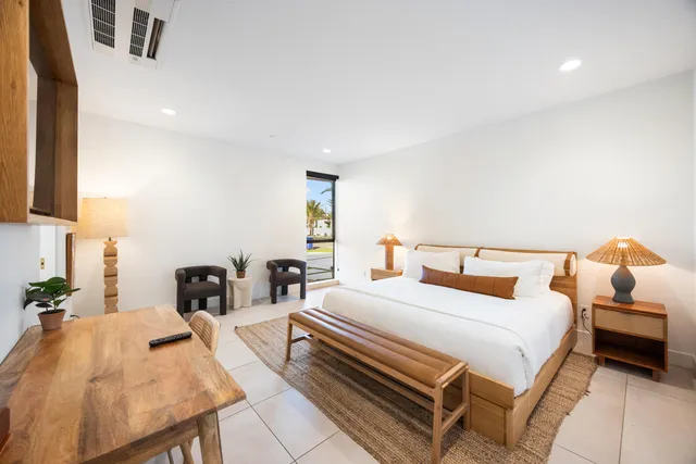 a bedroom with a bed and a night stand