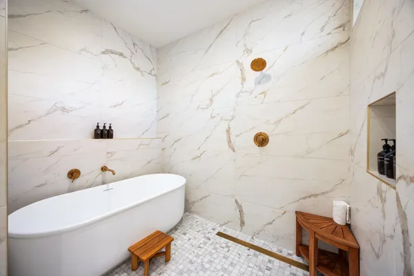 a bathroom with a tub and a shower