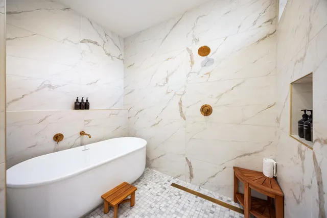 a bathroom with a tub and a shower