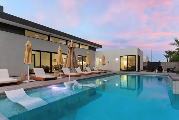 a view of a patio with swimming pool table and chairs