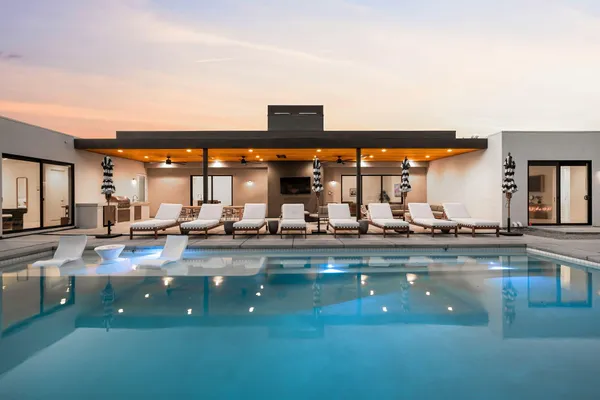 a view of swimming pool and outdoor seating