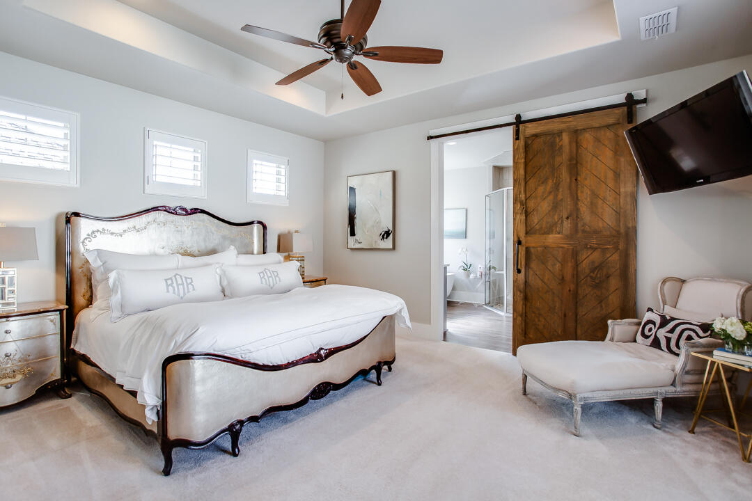 4301 138th Street Lubbock, TX 79423 - Photo 20 of 41 a spacious bedroom with a bed and a flat screen tv