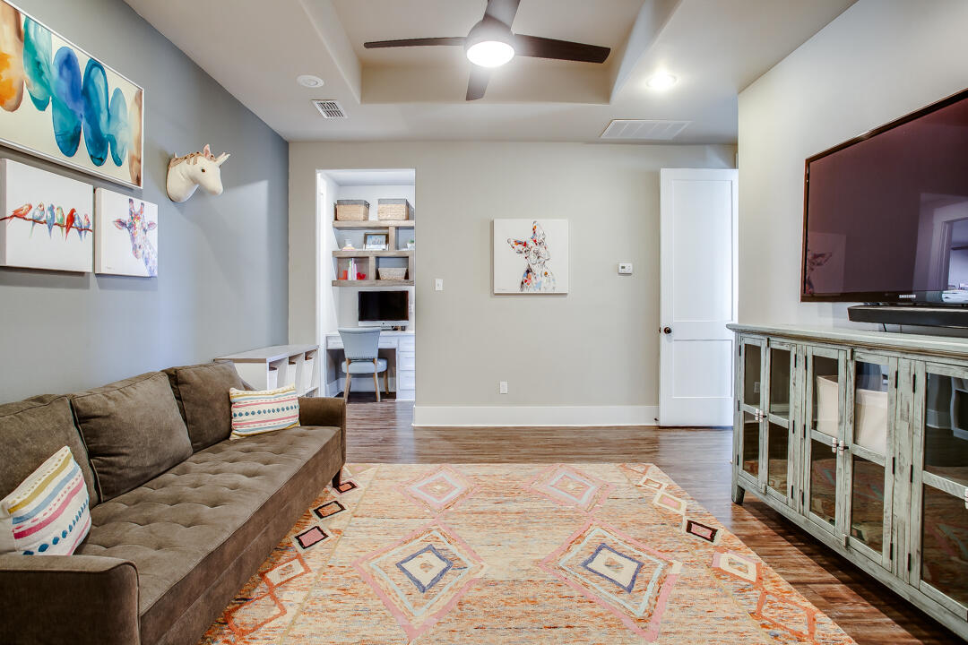 4301 138th Street Lubbock, TX 79423 - Photo 24 of 41 a living room with furniture and a flat screen tv