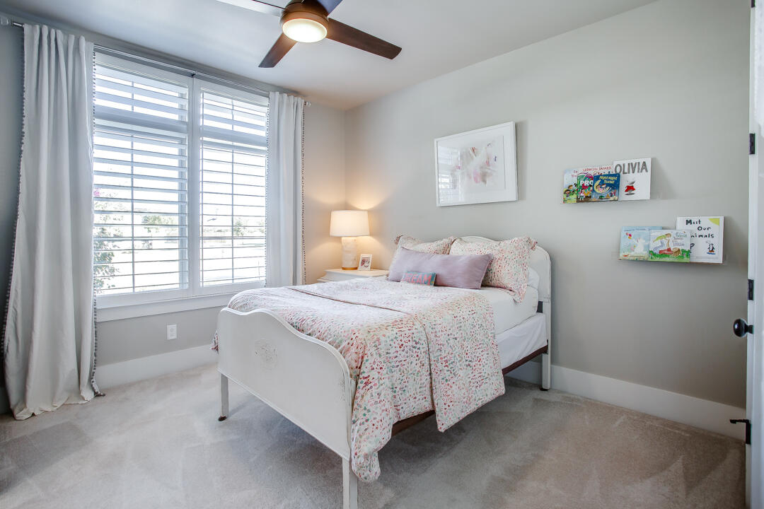 4301 138th Street Lubbock, TX 79423 - Photo 26 of 41 a bedroom with a bed and a chandelier