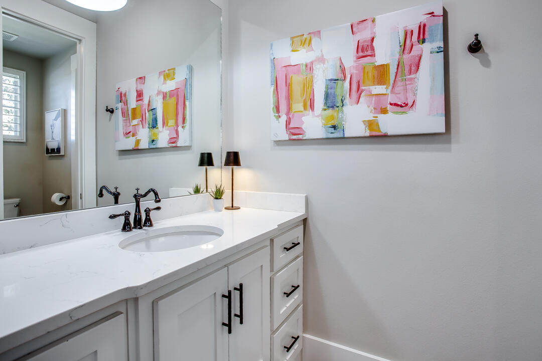 4301 138th Street Lubbock, TX 79423 - Photo 27 of 41 a bathroom with a sink a vanity and painting on the wall