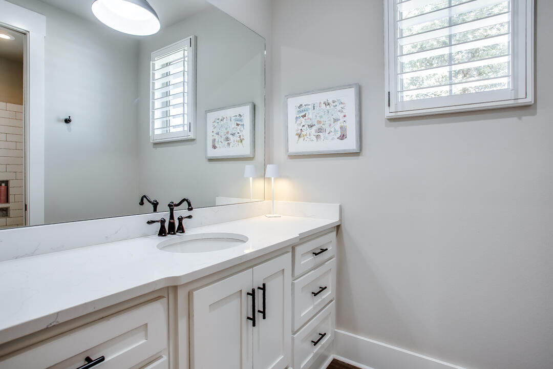 4301 138th Street Lubbock, TX 79423 - Photo 29 of 41 a bathroom with a sink a vanity and a window