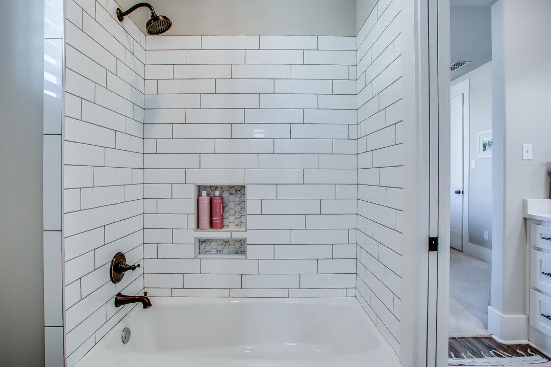 4301 138th Street Lubbock, TX 79423 - Photo 30 of 41 a bathroom with a bathtub and a shower