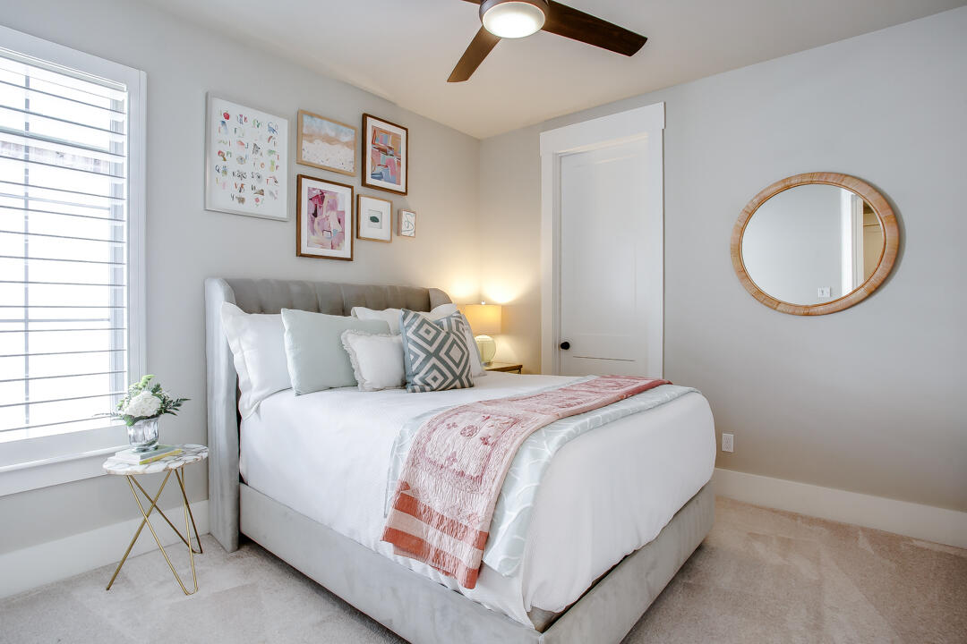 4301 138th Street Lubbock, TX 79423 - Photo 31 of 41 a bedroom with a bed and a chandelier