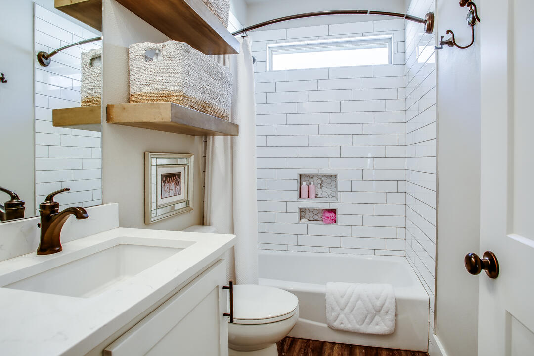 4301 138th Street Lubbock, TX 79423 - Photo 32 of 41 a bathroom with a sink a toilet and shower