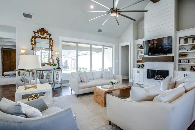 a living room with furniture and a fireplace