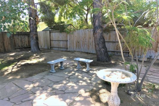1122 North Inyo Street Ridgecrest, CA 93555 - Photo 32 of 34 a backyard of a house with table and chairs