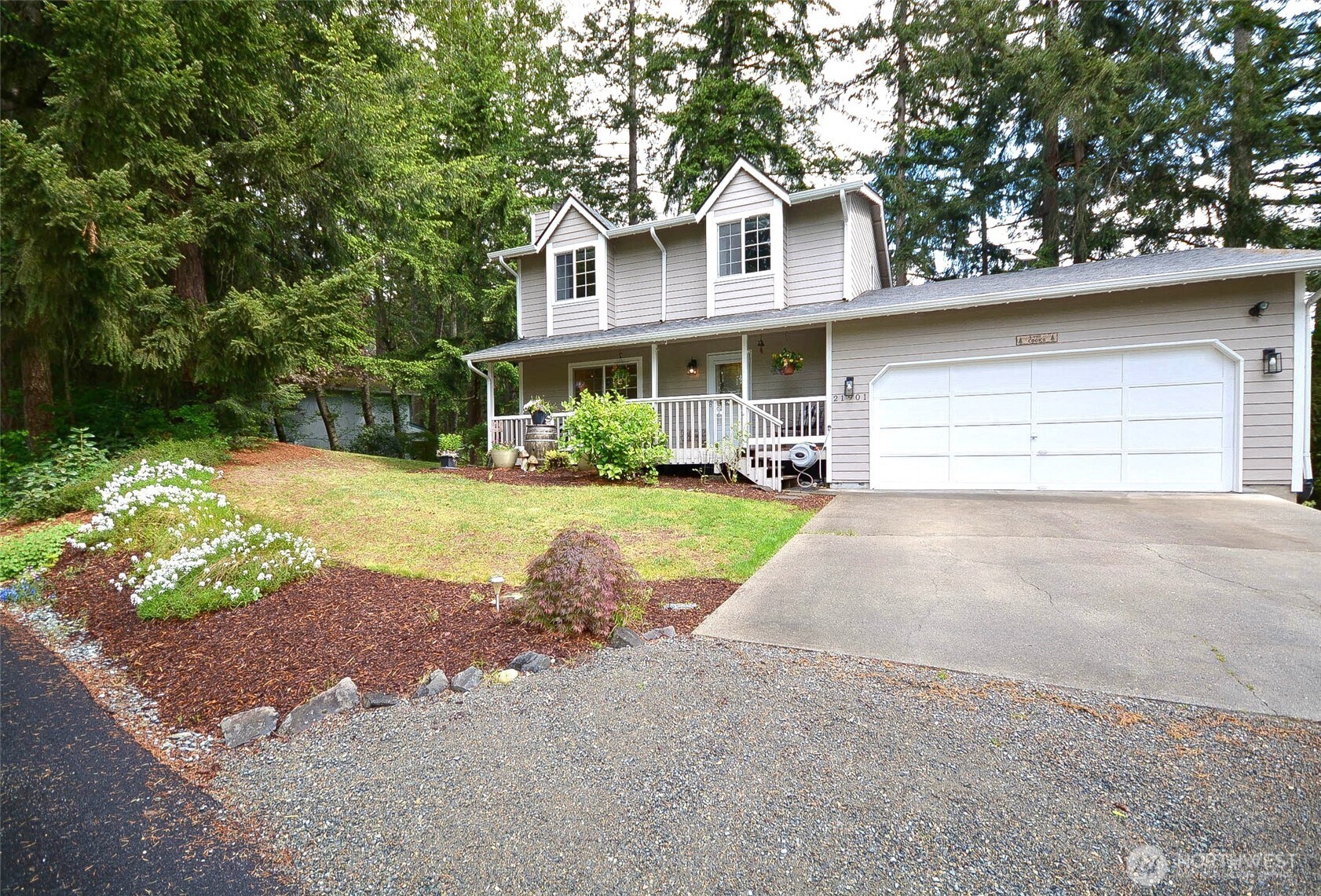 21901 North Clear Lake Boulevard Southeast Yelm, WA 98597 - Photo 1 of 40 a front view of a house with a yard and potted plants