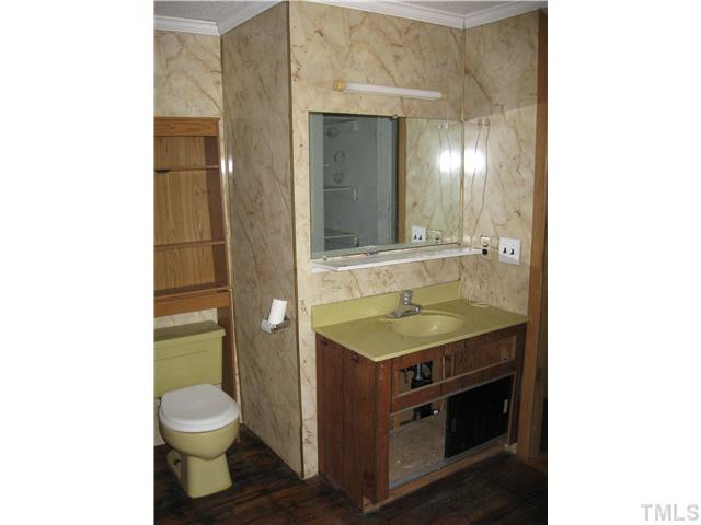 1585 Lettuce Hall Road Spring Hope, NC 27882 - Photo 9 of 11 a bathroom with a granite countertop toilet sink and mirror