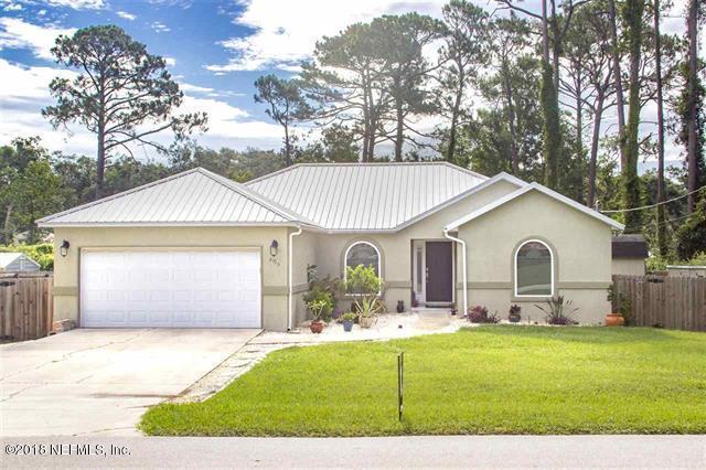 609 Queen Road St. Augustine, FL 32086 - Photo 1 of 35 a front view of a house with a yard and garage