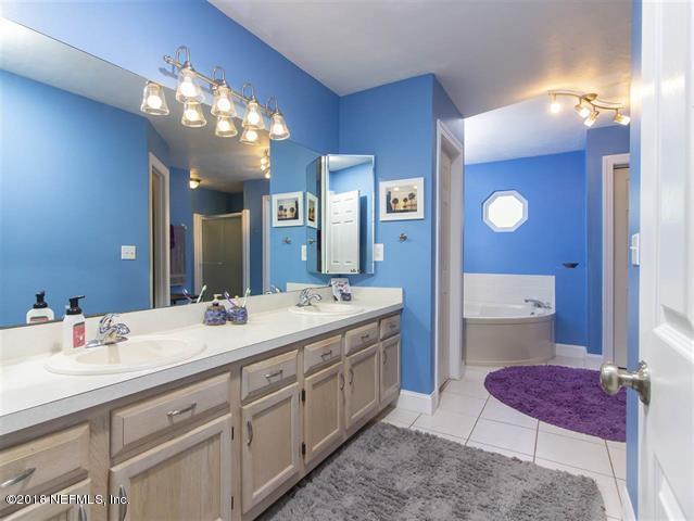 609 Queen Road St. Augustine, FL 32086 - Photo 12 of 35 a spacious bathroom with a granite countertop sink a toilet and a mirror