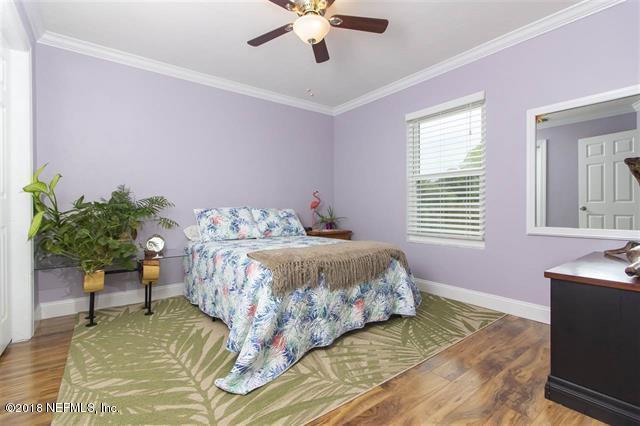 609 Queen Road St. Augustine, FL 32086 - Photo 15 of 35 a bedroom with a bed and a potted plant