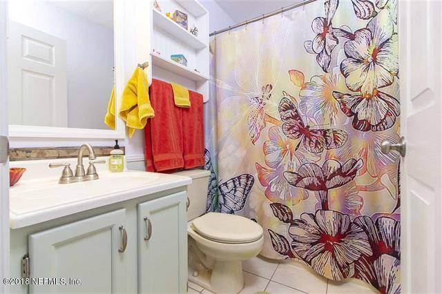 609 Queen Road St. Augustine, FL 32086 - Photo 16 of 35 a bathroom with a sink and mirror with toilet