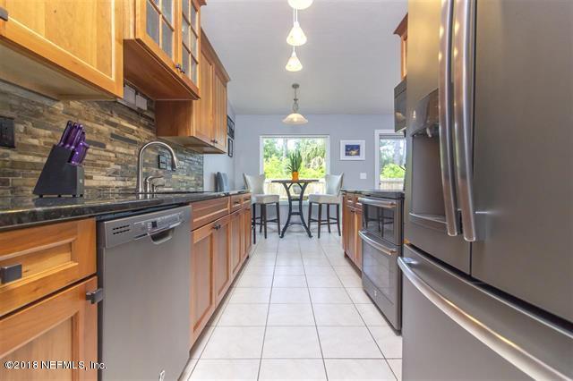 609 Queen Road St. Augustine, FL 32086 - Photo 29 of 35 a kitchen with stainless steel appliances granite countertop lots of counter top space and wooden floor