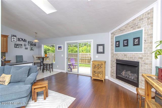 609 Queen Road St. Augustine, FL 32086 - Photo 3 of 35 a living room with furniture and a fireplace