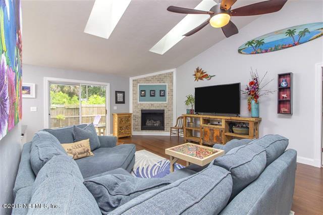609 Queen Road St. Augustine, FL 32086 - Photo 32 of 35 a living room with furniture a flat screen tv and a large window
