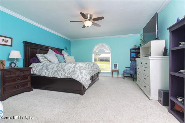 609 Queen Road St. Augustine, FL 32086 - Photo 34 of 35 a bedroom with a bed and a walk in closet