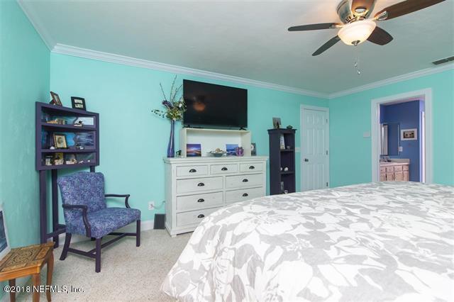 609 Queen Road St. Augustine, FL 32086 - Photo 35 of 35 a bedroom with a bed and a flat screen tv