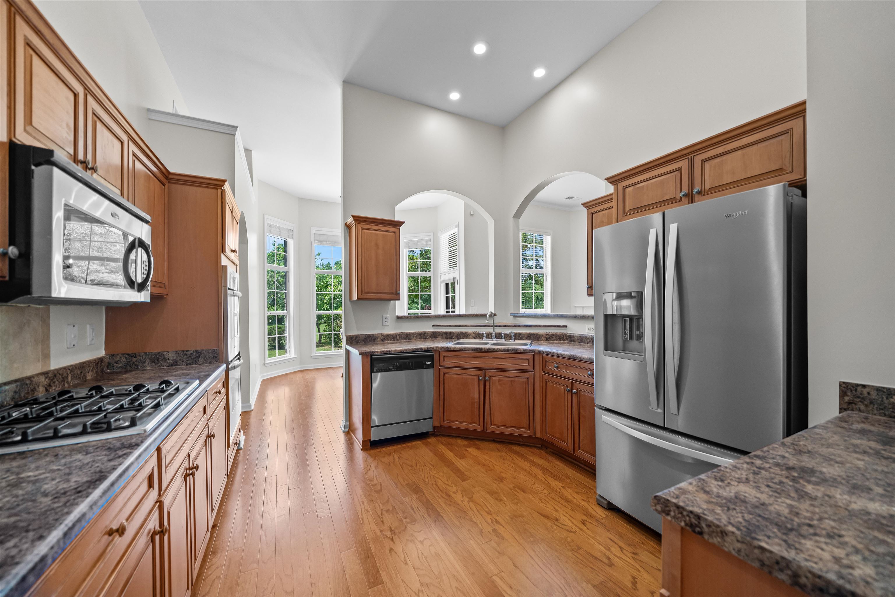 5035 Brian Ridge Road Arlington, TN 38002 - Photo 5 of 40 Spacious kitchen featuring wood-finish cabinetry, stainless steel appliances, recessed lighting, and wood-finish flooring