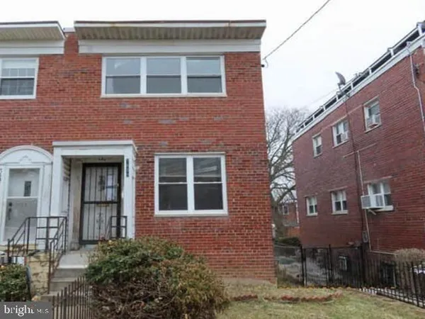 a view of a brick building next to a yard
