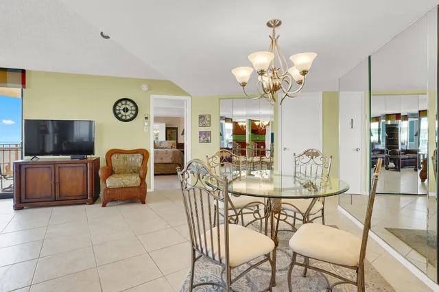 a view of a dining room with furniture and a large window