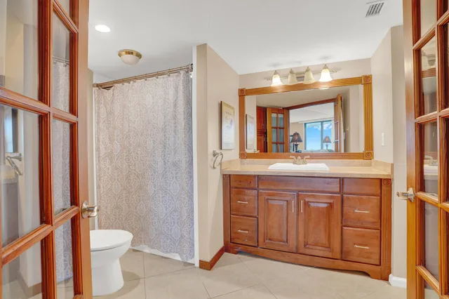 a bathroom with a toilet a sink and mirror