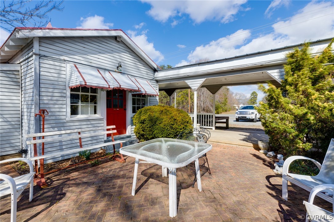 1037 Broad St Road Manakin-Sabot, VA 23103 - Photo 19 of 50 a patio with table and chairs and potted plants