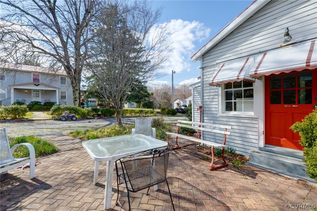 1037 Broad St Road Manakin-Sabot, VA 23103 - Photo 20 of 50 a view of a patio with table and chairs near a yard